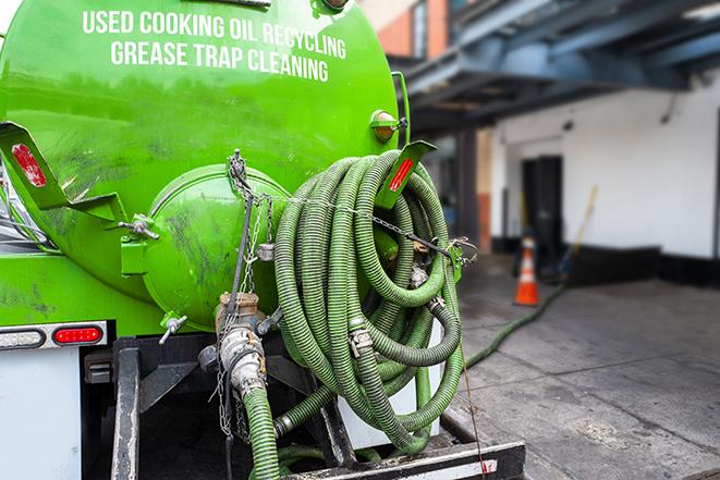 a technician pumping a grease trap in a commercial building in Newburgh Heights OH